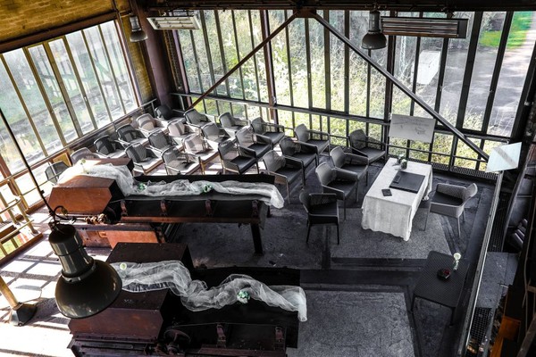 Blick von oben auf das Szenario für eine Trauung in der verglasten Übergabestation mit Tisch und Stühlen für die Gäste