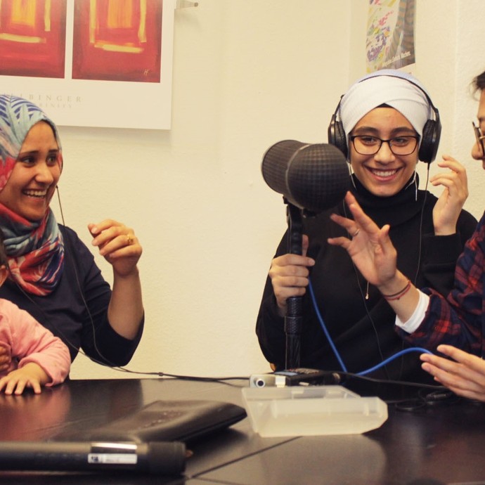 Making of der Ausstellung: Frauen mit Kopfhörern lachen und halten ein Mikrofon. (vergrößerte Bildansicht wird geöffnet)